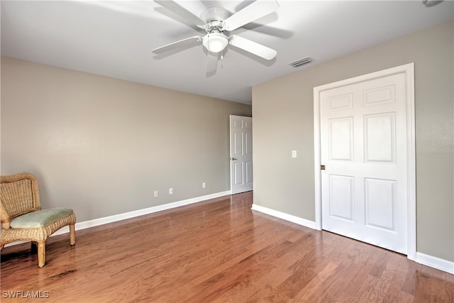 unfurnished room featuring hardwood / wood-style flooring and ceiling fan