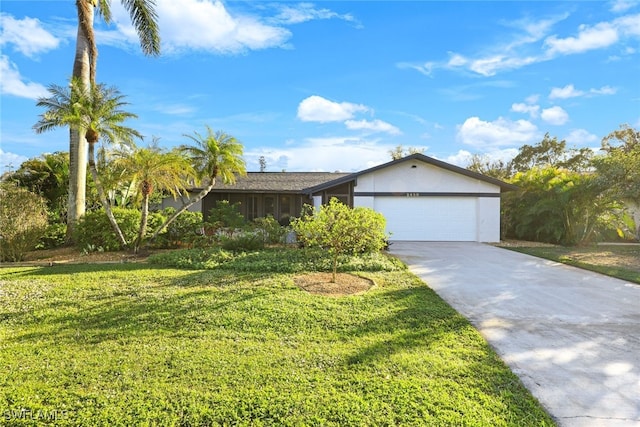 ranch-style home featuring a front lawn and a garage