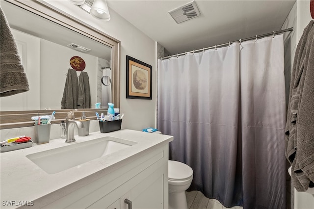 bathroom featuring tile patterned flooring, vanity, and toilet