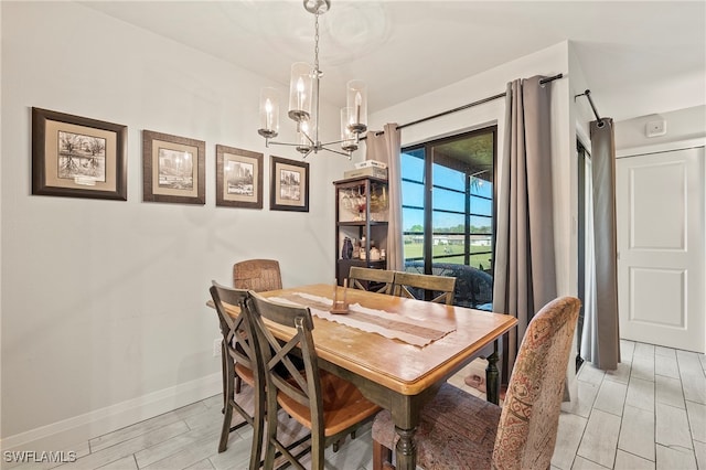 dining room featuring a chandelier and light wood-type flooring