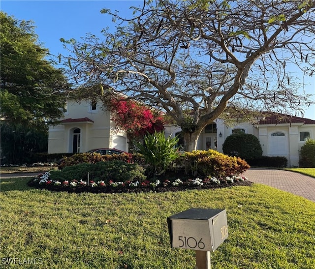 mediterranean / spanish home featuring a front lawn