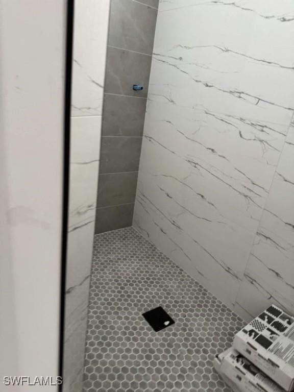 bathroom with tiled shower