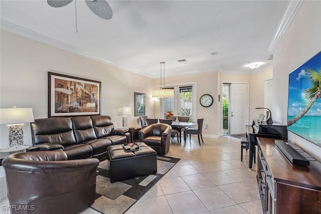 living area with visible vents, ornamental molding, a ceiling fan, light tile patterned floors, and baseboards