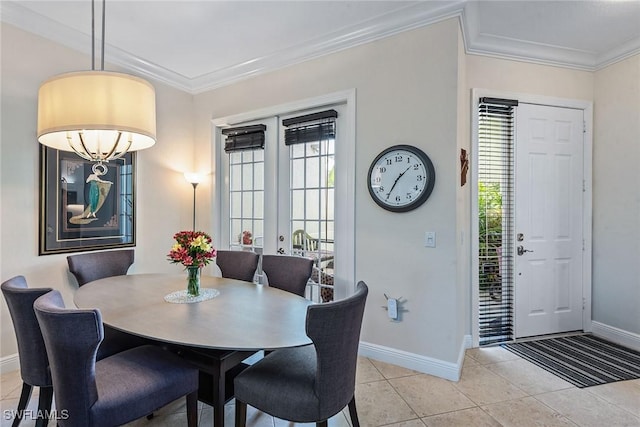 dining space featuring light tile patterned floors, plenty of natural light, and crown molding