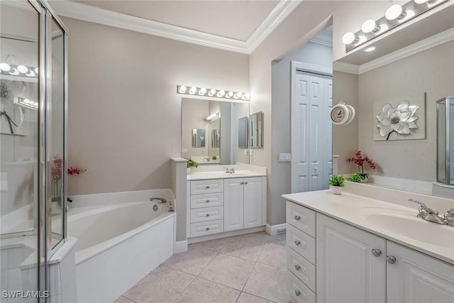 bathroom with a garden tub, two vanities, a sink, crown molding, and tile patterned floors