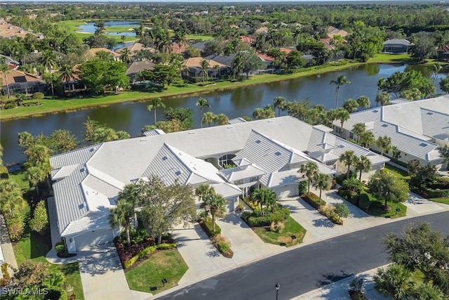 drone / aerial view featuring a residential view and a water view