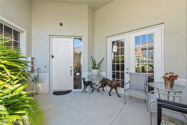 doorway to property with french doors and stucco siding