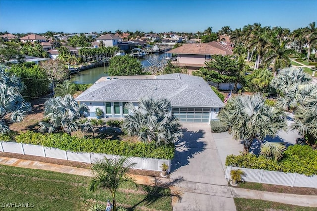 drone / aerial view featuring a water view and a residential view