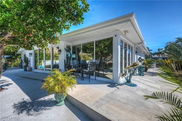 view of patio / terrace featuring a sunroom