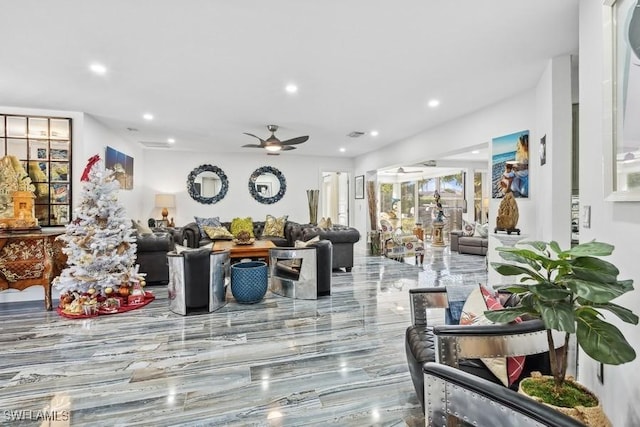 living area with a ceiling fan and recessed lighting