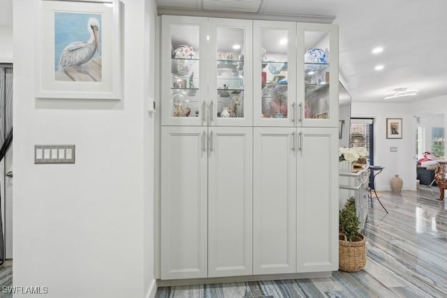 interior space with recessed lighting, visible vents, baseboards, and wood finished floors