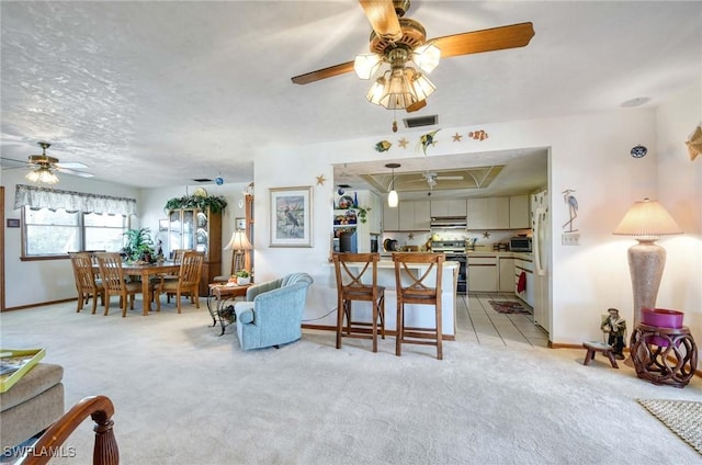 living room with ceiling fan and light carpet