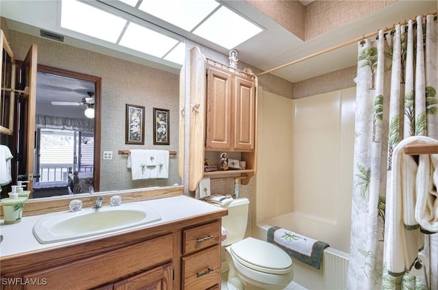 full bathroom with vanity, toilet, ceiling fan, and shower / bath combo with shower curtain