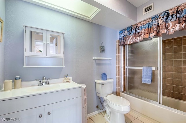 full bathroom with toilet, vanity, tile patterned floors, and enclosed tub / shower combo