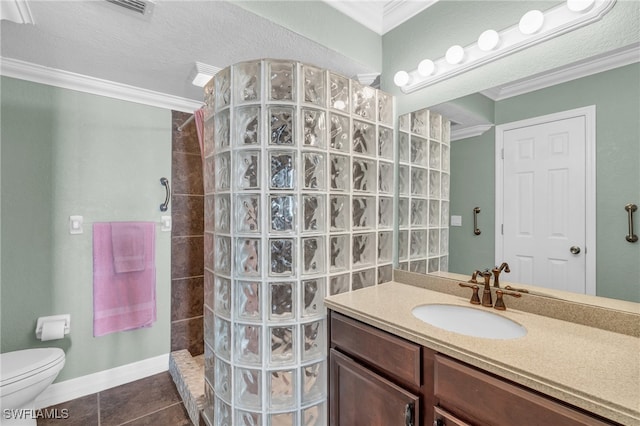 bathroom featuring vanity, tile patterned floors, ornamental molding, a textured ceiling, and a tile shower