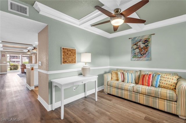 living room featuring ceiling fan, coffered ceiling, beamed ceiling, crown molding, and hardwood / wood-style flooring