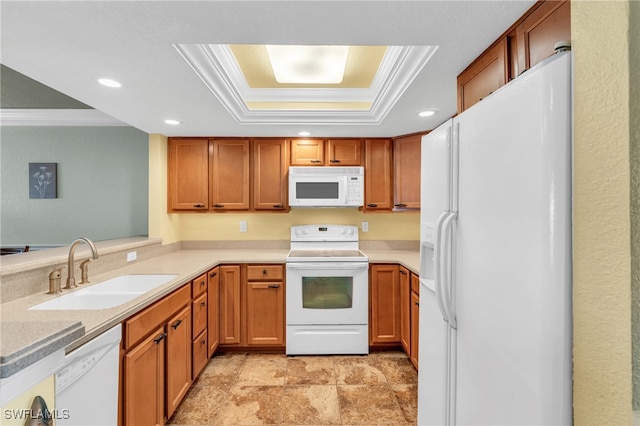 kitchen featuring a tray ceiling, sink, white appliances, and ornamental molding