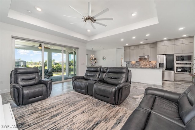 living room featuring a tray ceiling