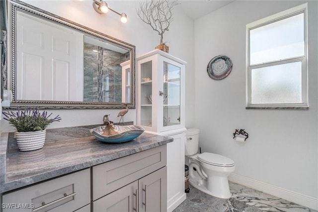 bathroom with vanity, a shower with shower door, and toilet