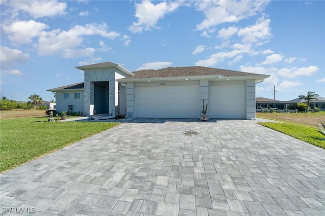 view of front of home with a front yard and a garage