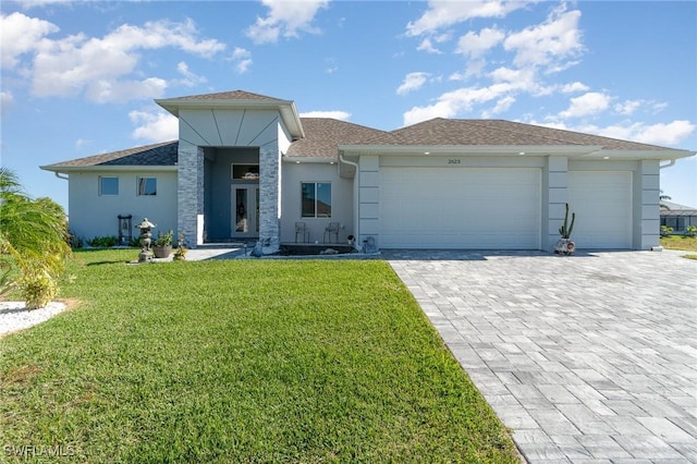 view of front facade with a garage and a front lawn