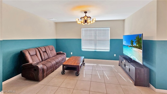 living room with a chandelier and light tile patterned flooring