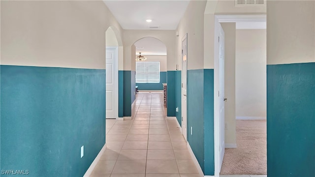 hall with light tile patterned floors