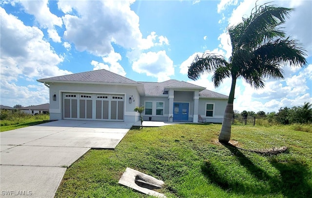 view of front of house featuring a garage and a front yard