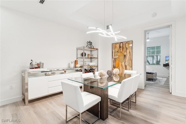 dining space with light wood-type flooring and ceiling fan