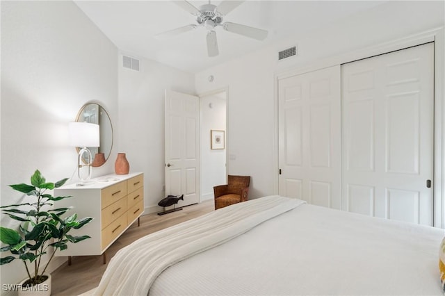 bedroom with ceiling fan, a closet, and light hardwood / wood-style floors