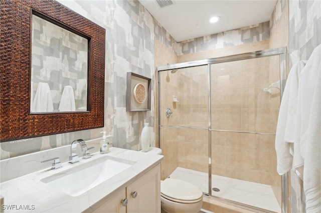 bathroom with vanity, toilet, and walk in shower