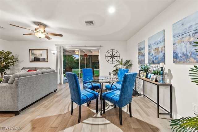 dining room with light hardwood / wood-style flooring and ceiling fan