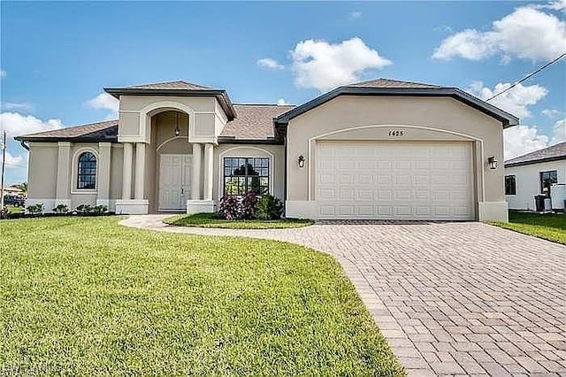 view of front of house with a garage and a front lawn