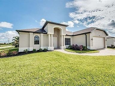 view of front facade with a garage and a front lawn