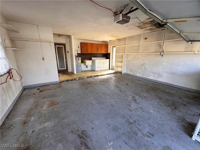 garage with sink, a garage door opener, and independent washer and dryer