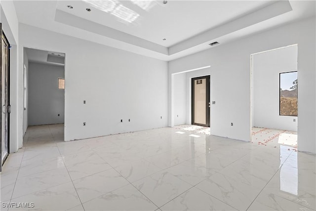 empty room featuring a tray ceiling