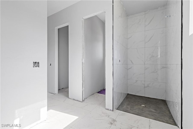 bathroom with a tile shower