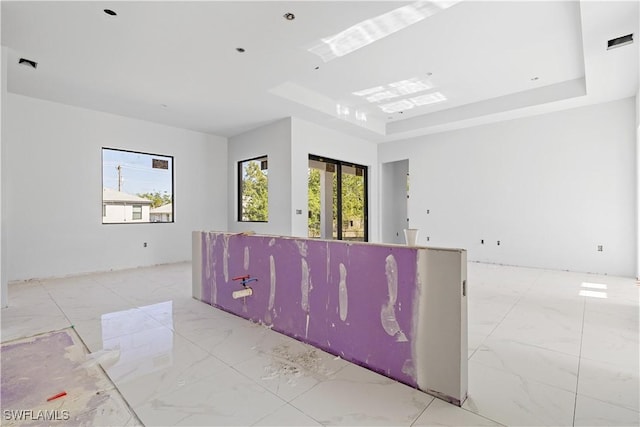 unfurnished room with a raised ceiling