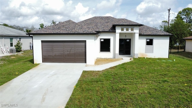 view of front of property with concrete driveway, an attached garage, a front lawn, and central air condition unit