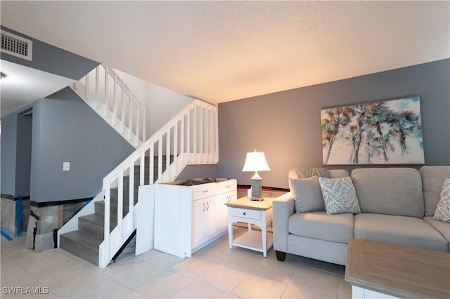 living room featuring light tile patterned floors and a textured ceiling