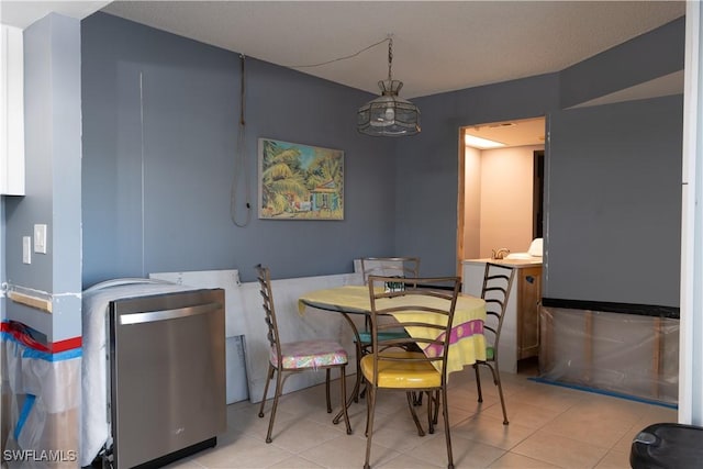 tiled dining area featuring a chandelier