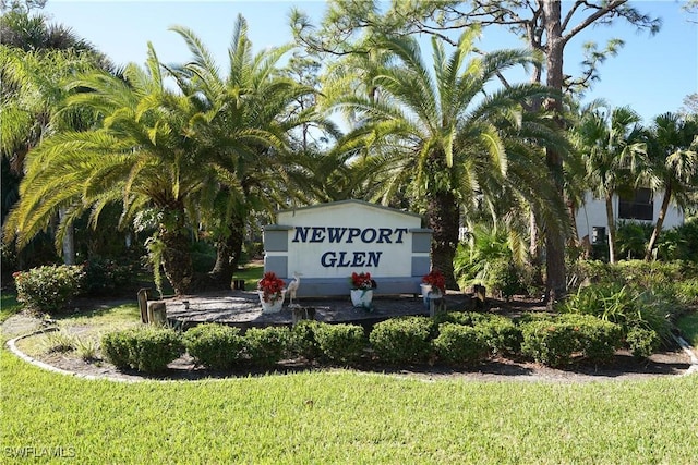 community sign featuring a lawn