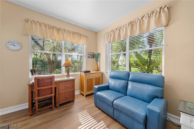 sitting room featuring baseboards and light wood finished floors