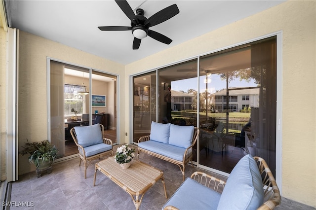 sunroom featuring a ceiling fan