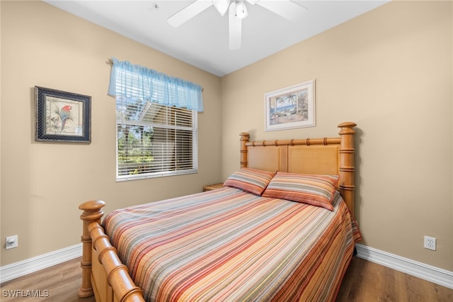 bedroom featuring ceiling fan, baseboards, and wood finished floors