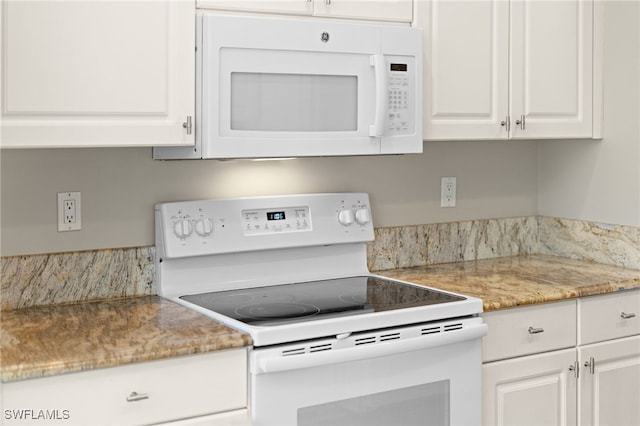 kitchen with white appliances and white cabinets