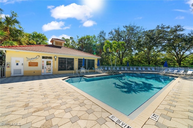 pool with fence and a patio