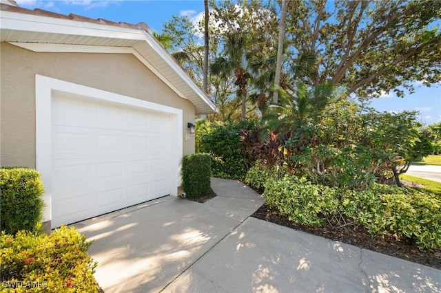 garage featuring concrete driveway