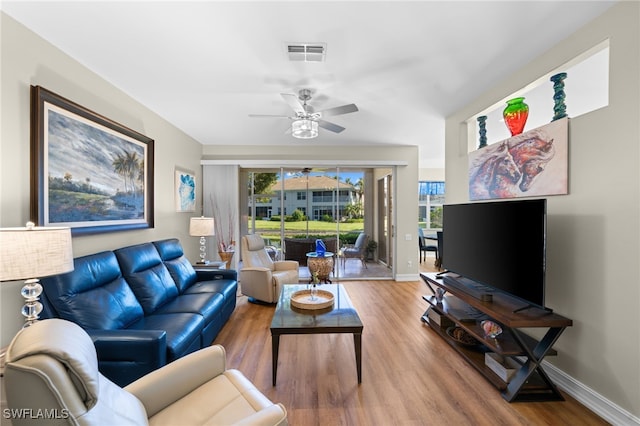 living room with visible vents, a ceiling fan, baseboards, and wood finished floors