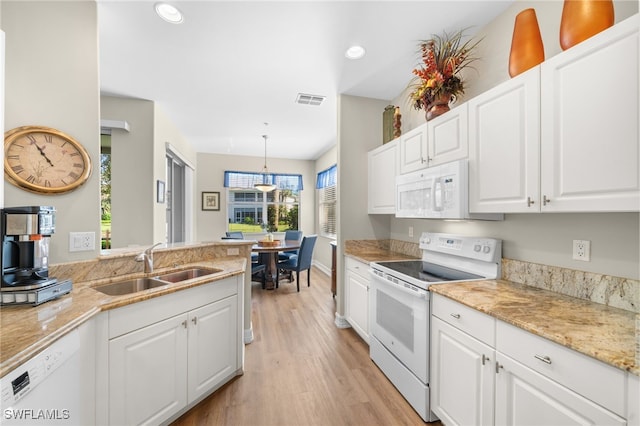 kitchen with white appliances, visible vents, white cabinetry, pendant lighting, and a sink